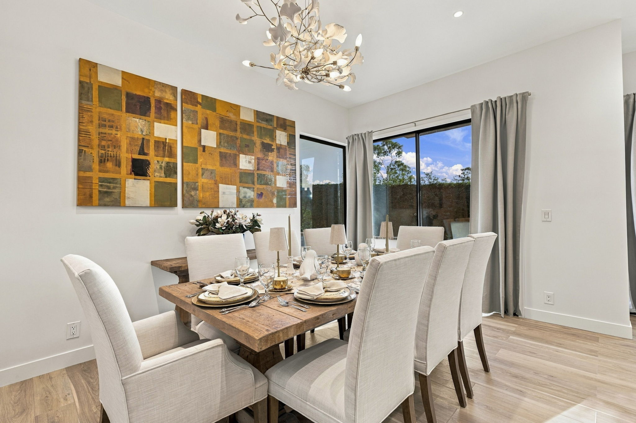 Dining table with upholstered chairs and sculptural lighting