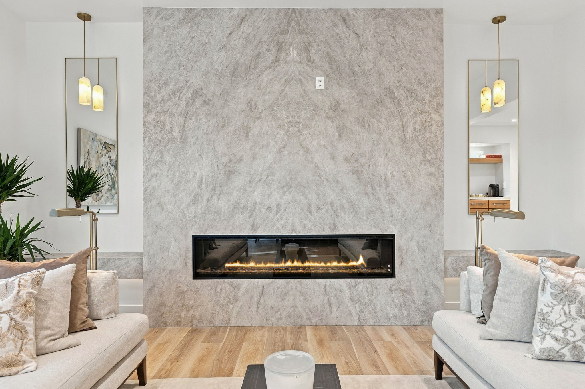 Stone fireplace and layered neutral furnishings at the Irvine residence