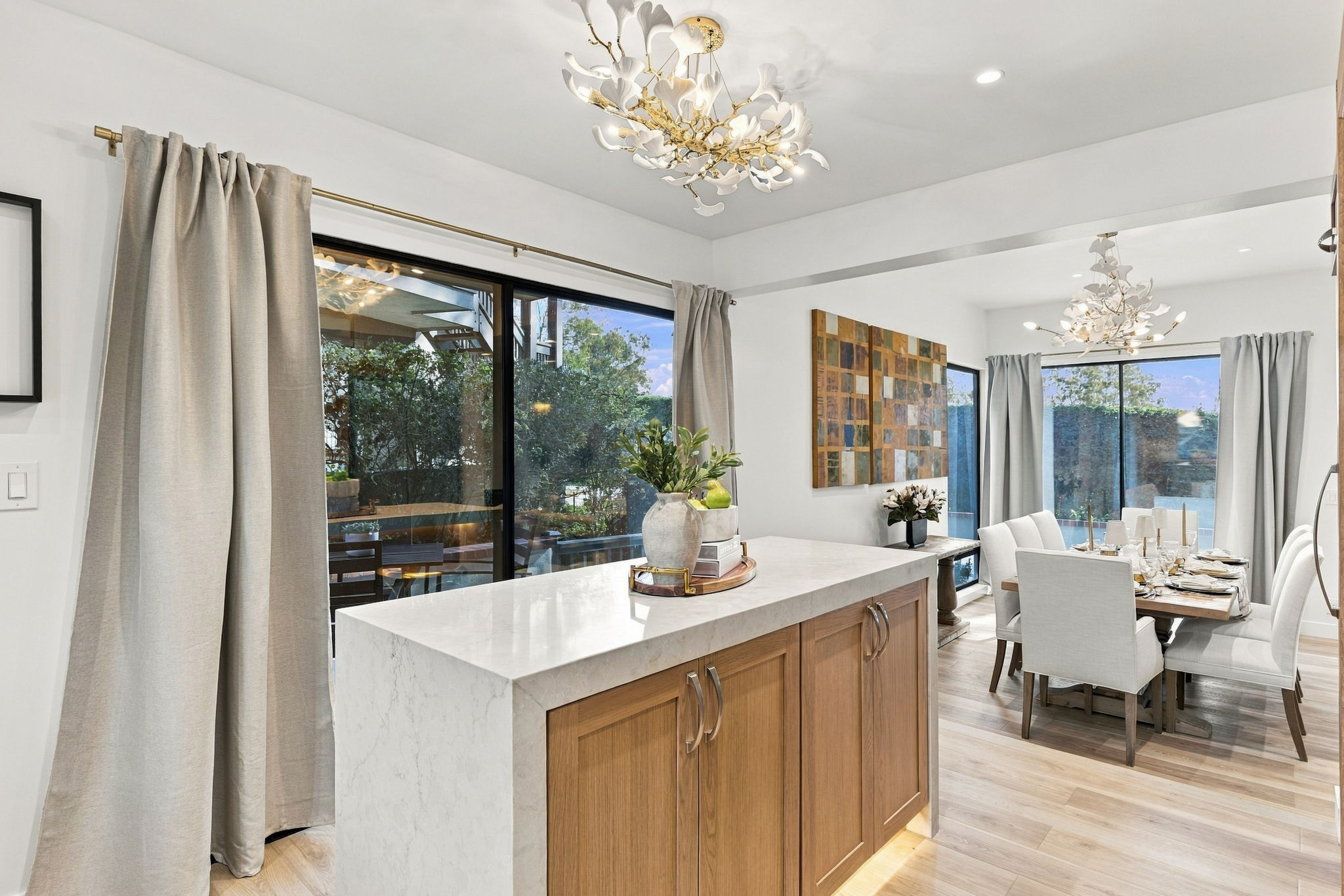 Oak kitchen island connecting to the bright dining area