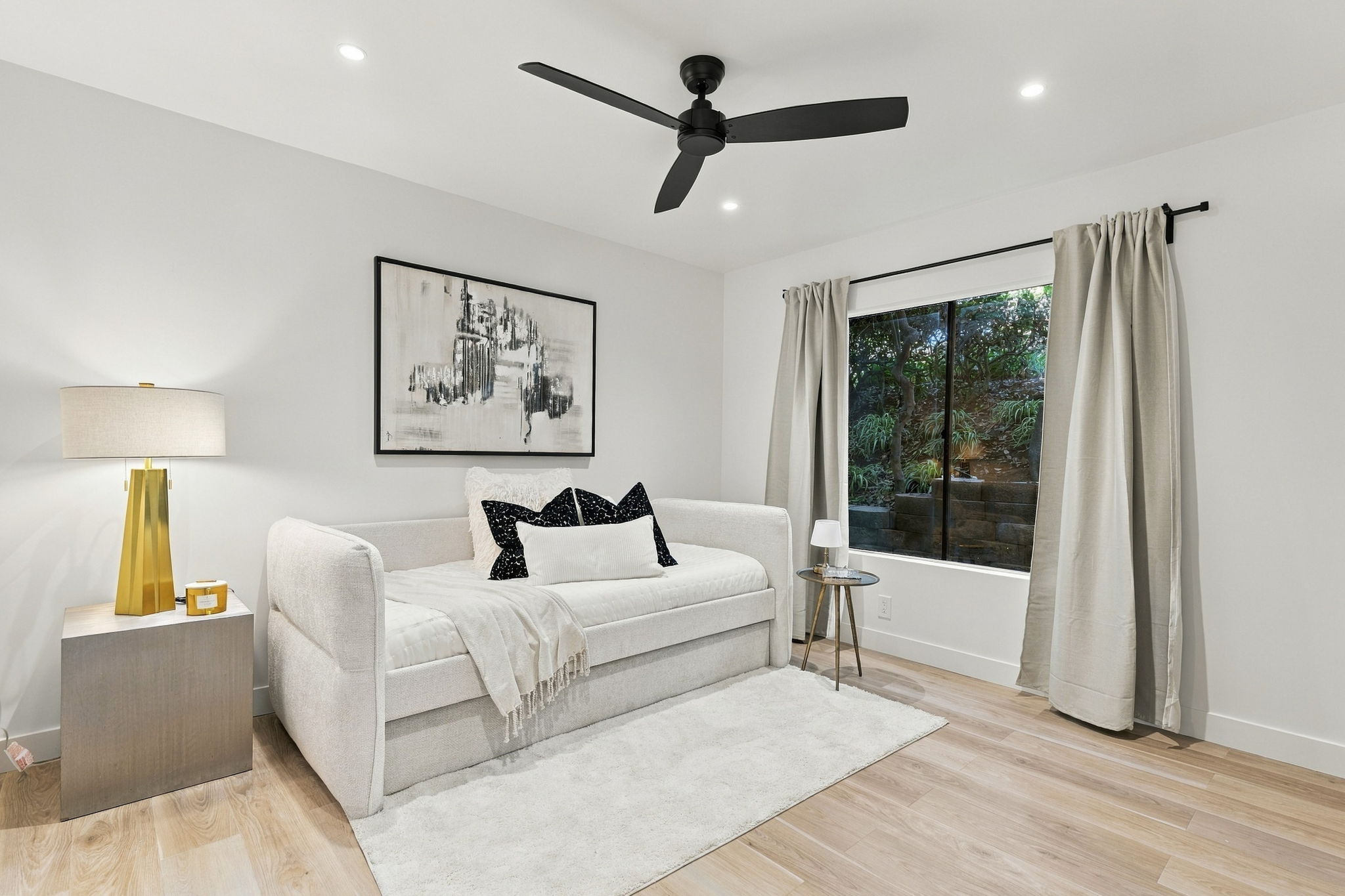 Guest bedroom with cream bedding and black accent pillows